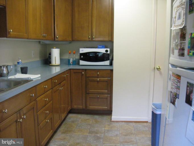 6900 Fieldcrest Road Baltimore, MD 21215 - Photo 15 of 15 a kitchen with a sink and cabinets