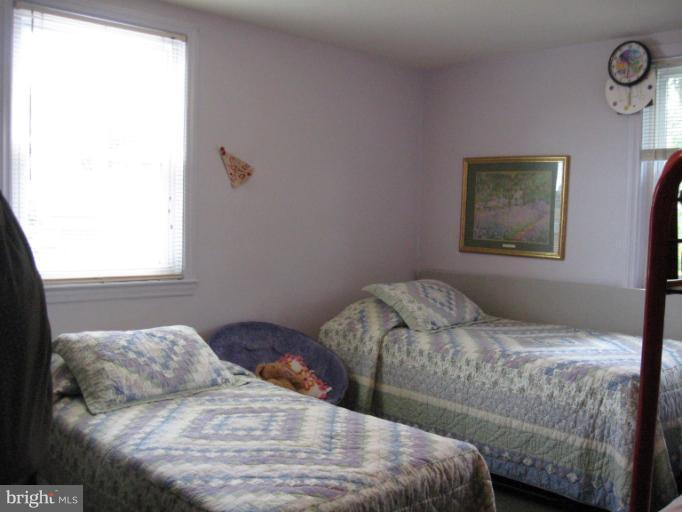 6900 Fieldcrest Road Baltimore, MD 21215 - Photo 5 of 15 a bedroom with a bed and a window