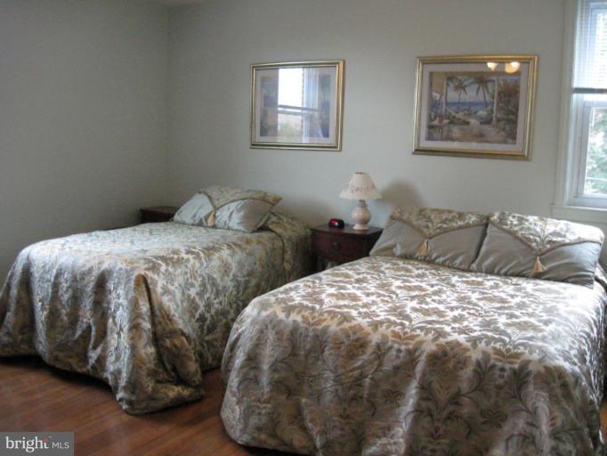 6900 Fieldcrest Road Baltimore, MD 21215 - Photo 6 of 15 a bedroom with two beds and a couch