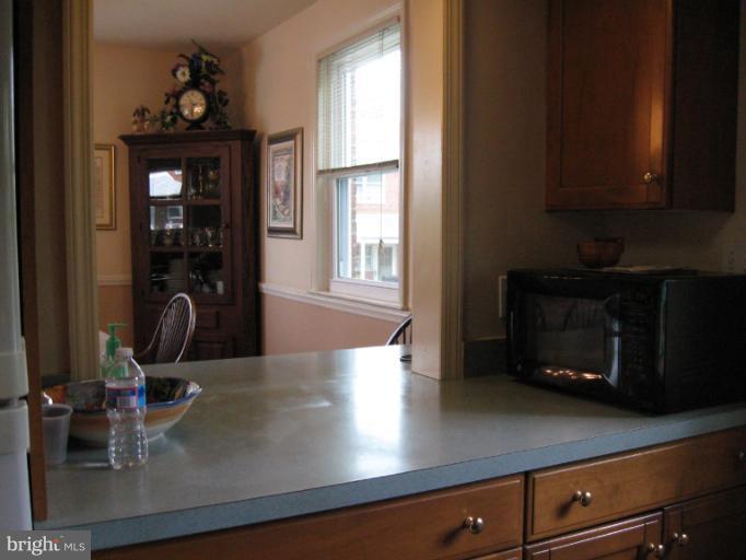6900 Fieldcrest Road Baltimore, MD 21215 - Photo 9 of 15 a kitchen with a microwave a stove and cabinets