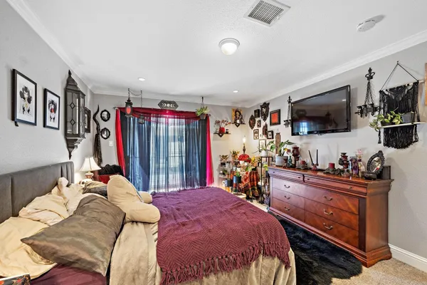 a bed room with a bed a television and a couch