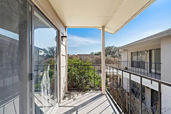 a view of a balcony with wooden floor