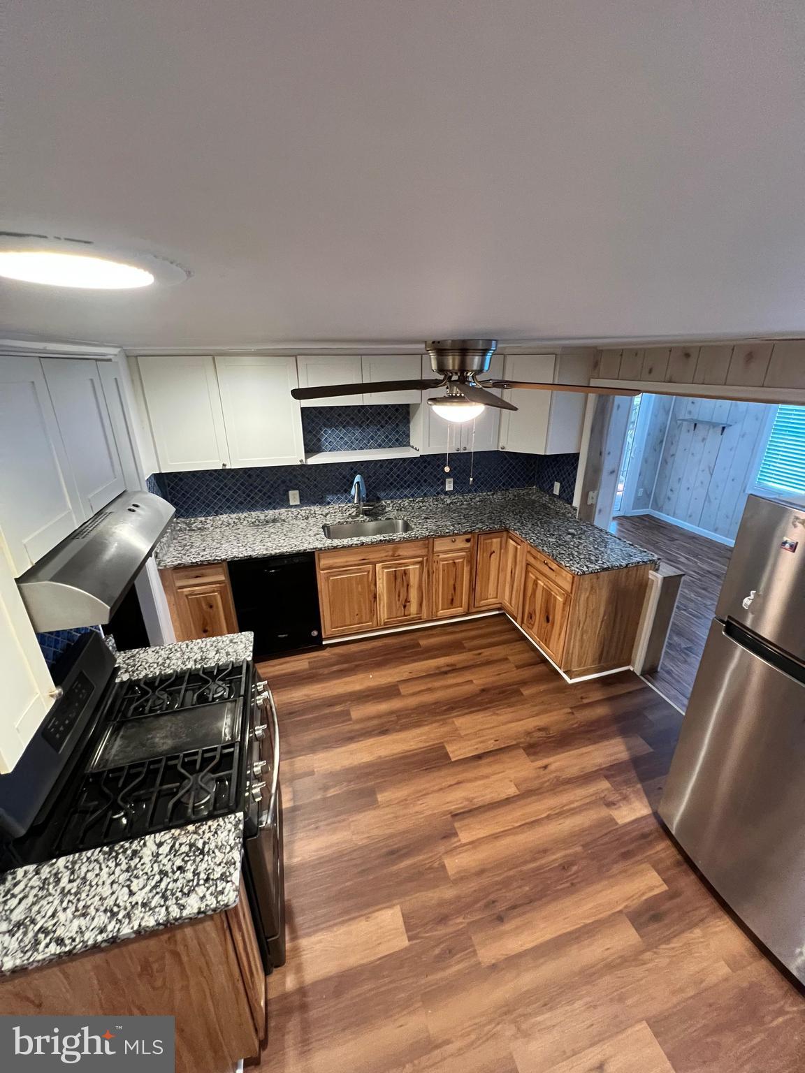 4440 Annapolis Road Halethorpe, MD 21227 - Photo 20 of 37 a kitchen with kitchen island a stove and a sink