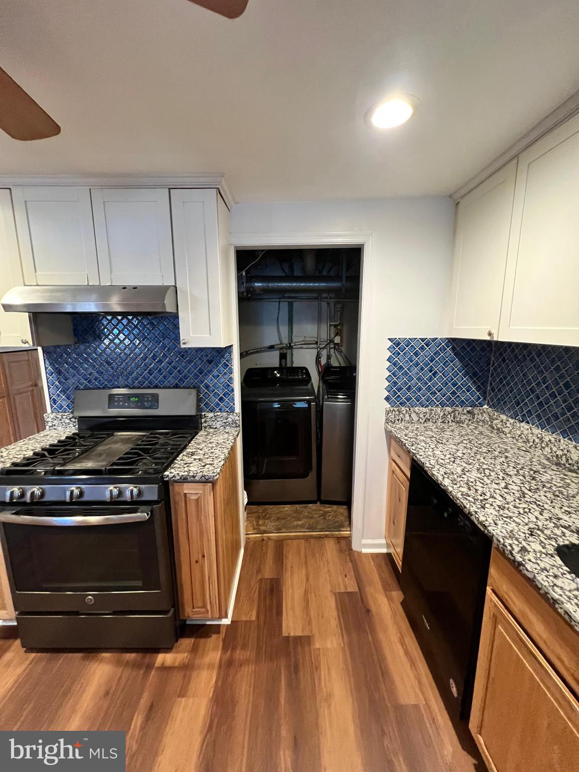 4440 Annapolis Road Halethorpe, MD 21227 - Photo 21 of 37 a kitchen with granite countertop wooden cabinets and stainless steel appliances