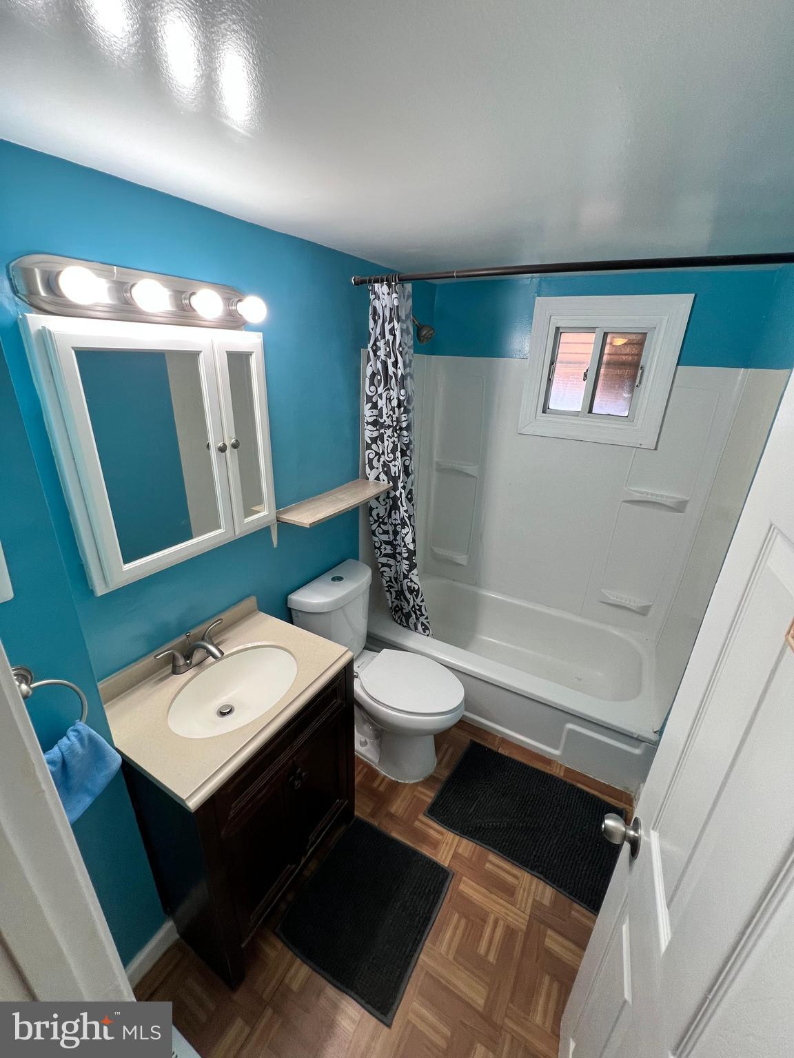 4440 Annapolis Road Halethorpe, MD 21227 - Photo 30 of 37 a bathroom with a toilet a sink and mirror