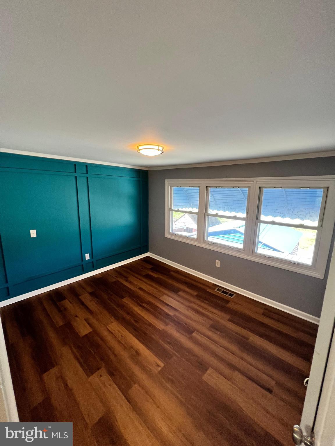 4440 Annapolis Road Halethorpe, MD 21227 - Photo 31 of 37 a view of empty room with window and wooden floor
