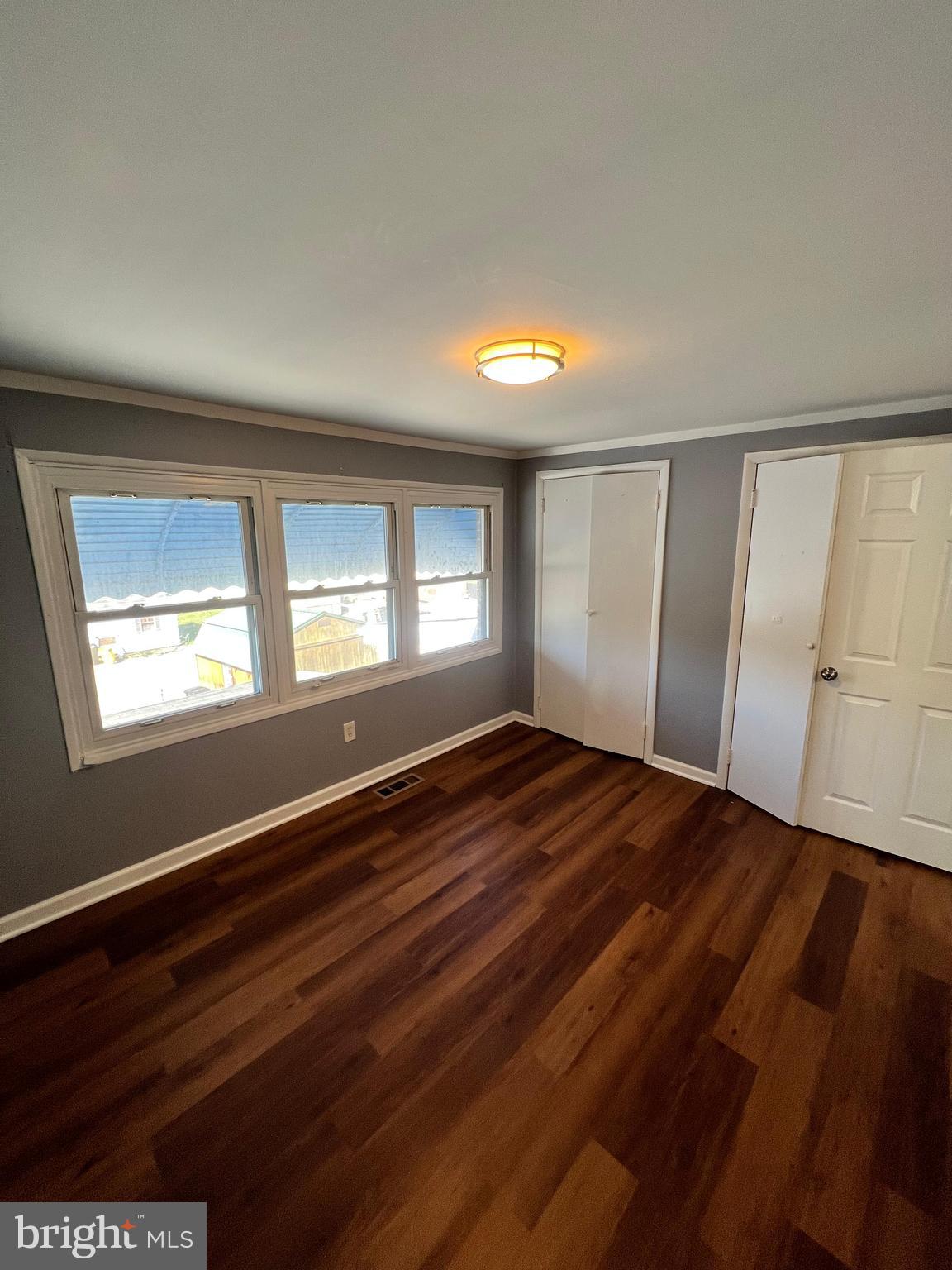 4440 Annapolis Road Halethorpe, MD 21227 - Photo 32 of 37 a view of an empty room with wooden floor and a window