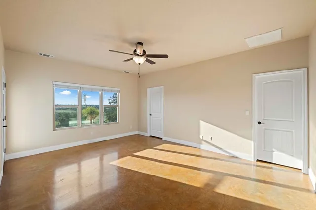 a view of a room that has a large window and front view