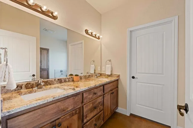 a bathroom with a tub shower and sink
