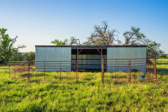 a view of a house with wooden fence