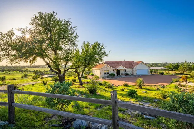 a view of house with yard and seating space