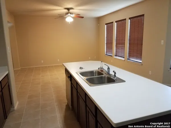 a view of a kitchen that has a sink a stove and microwave