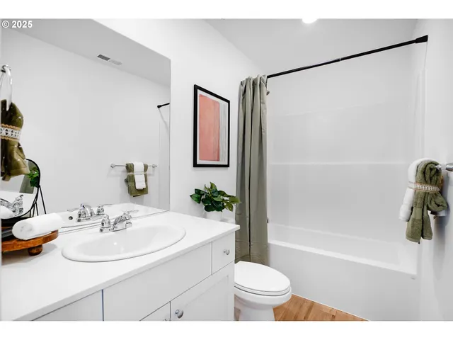 a view of bedroom with furniture and mirror