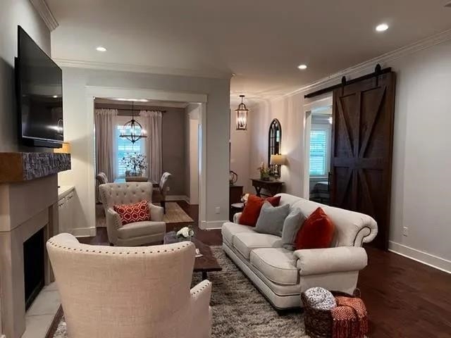 498 South Shea Road Collierville, TN 38017 - Photo 3 of 17 Sitting room featuring baseboards, recessed lighting, a fireplace, crown molding, and a barn door