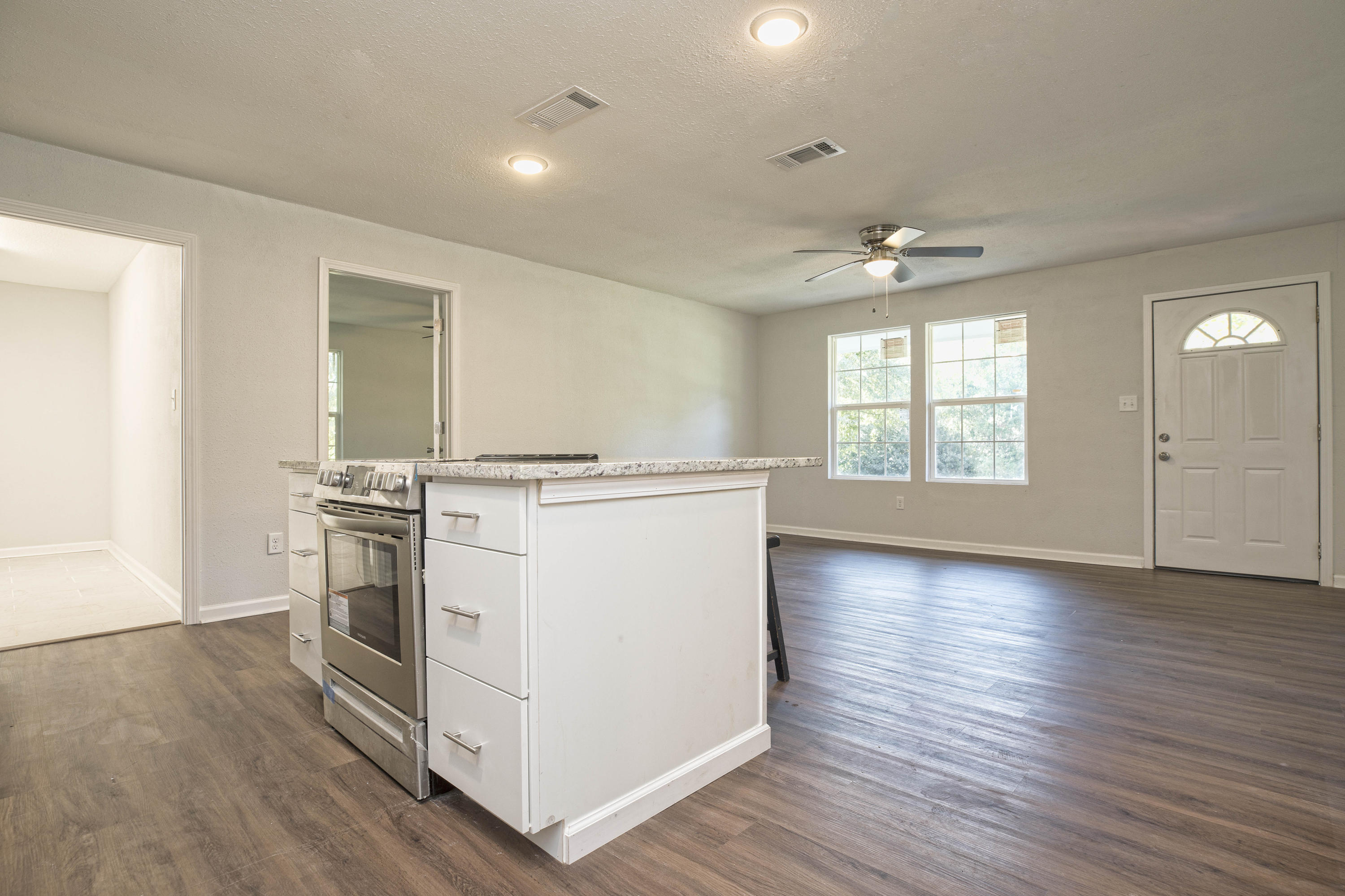 695 Ridge Lake Road Crestview, FL 32536 - Photo 13 of 27 wooden floor in an empty room with a window and wooden floor