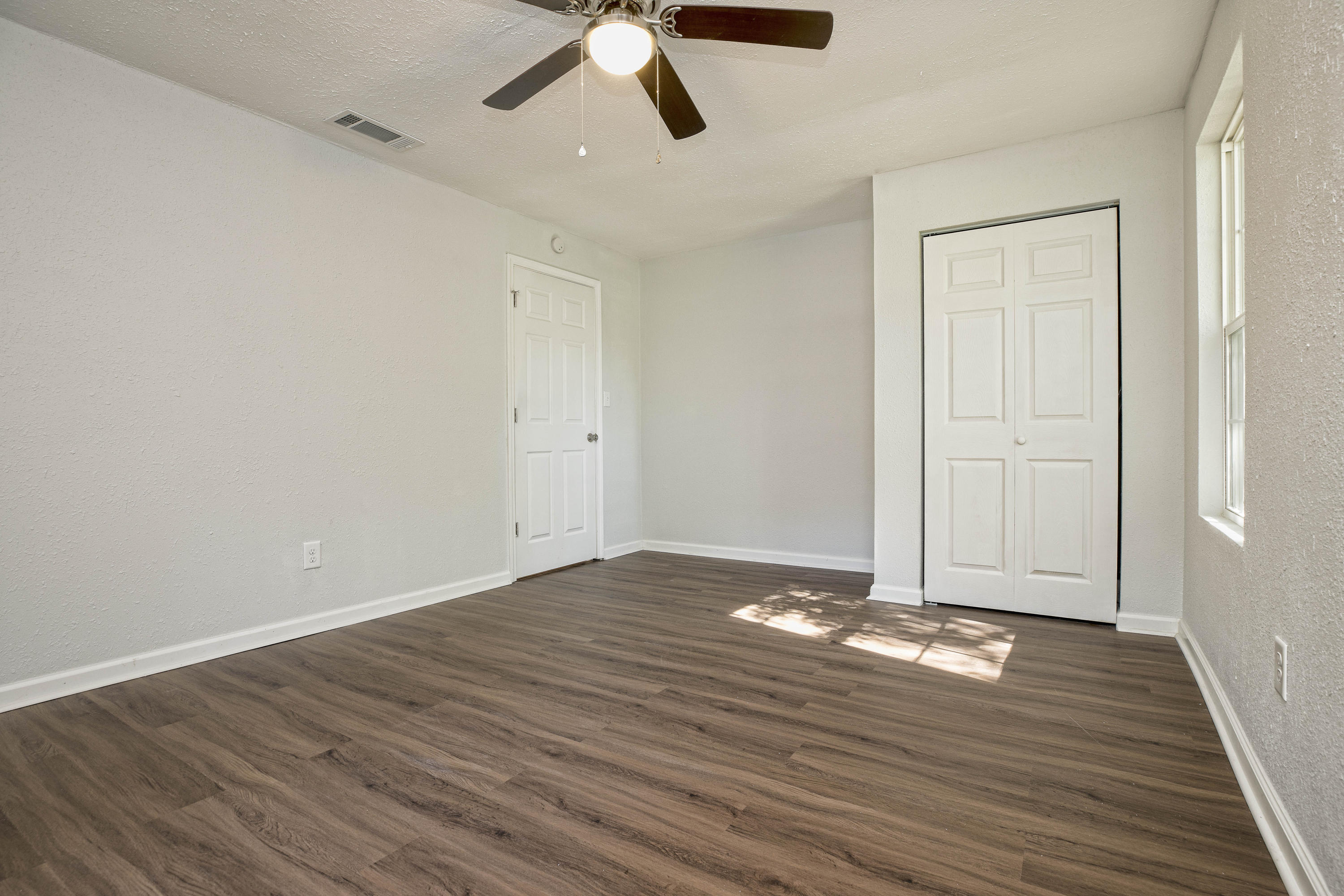 695 Ridge Lake Road Crestview, FL 32536 - Photo 14 of 27 a view of an empty room with wooden floor