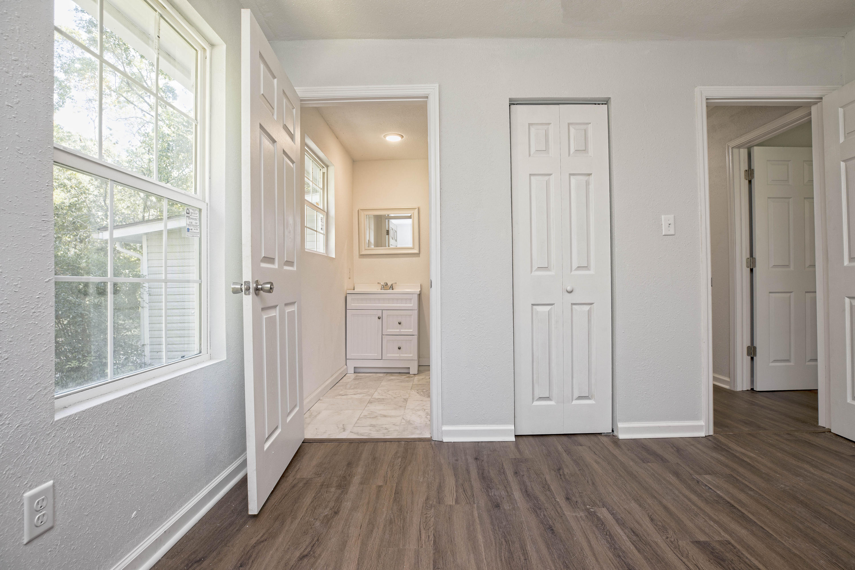695 Ridge Lake Road Crestview, FL 32536 - Photo 17 of 27 an empty room with wooden floor and windows