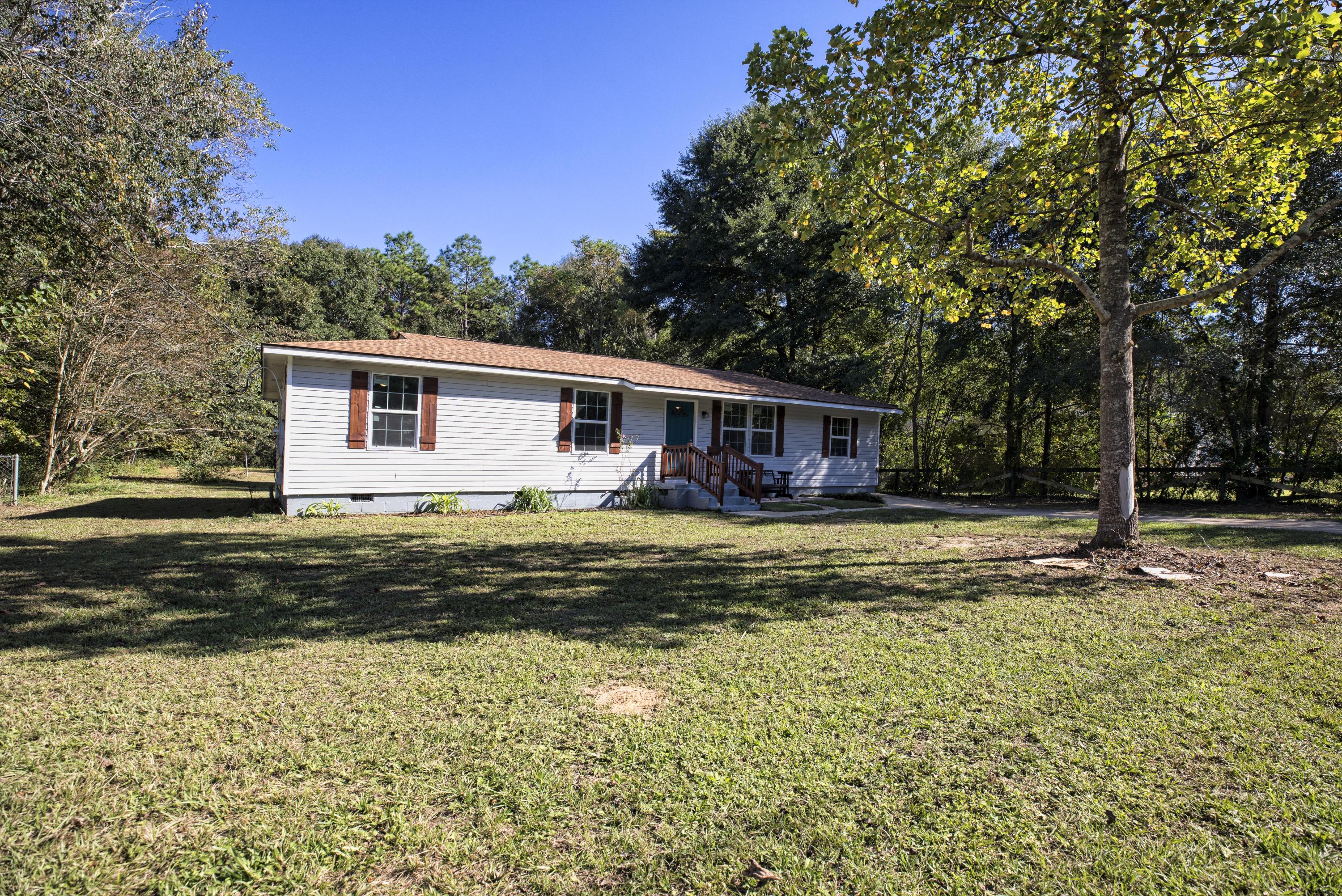 695 Ridge Lake Road Crestview, FL 32536 - Photo 2 of 27 a view of a house with pool and chairs