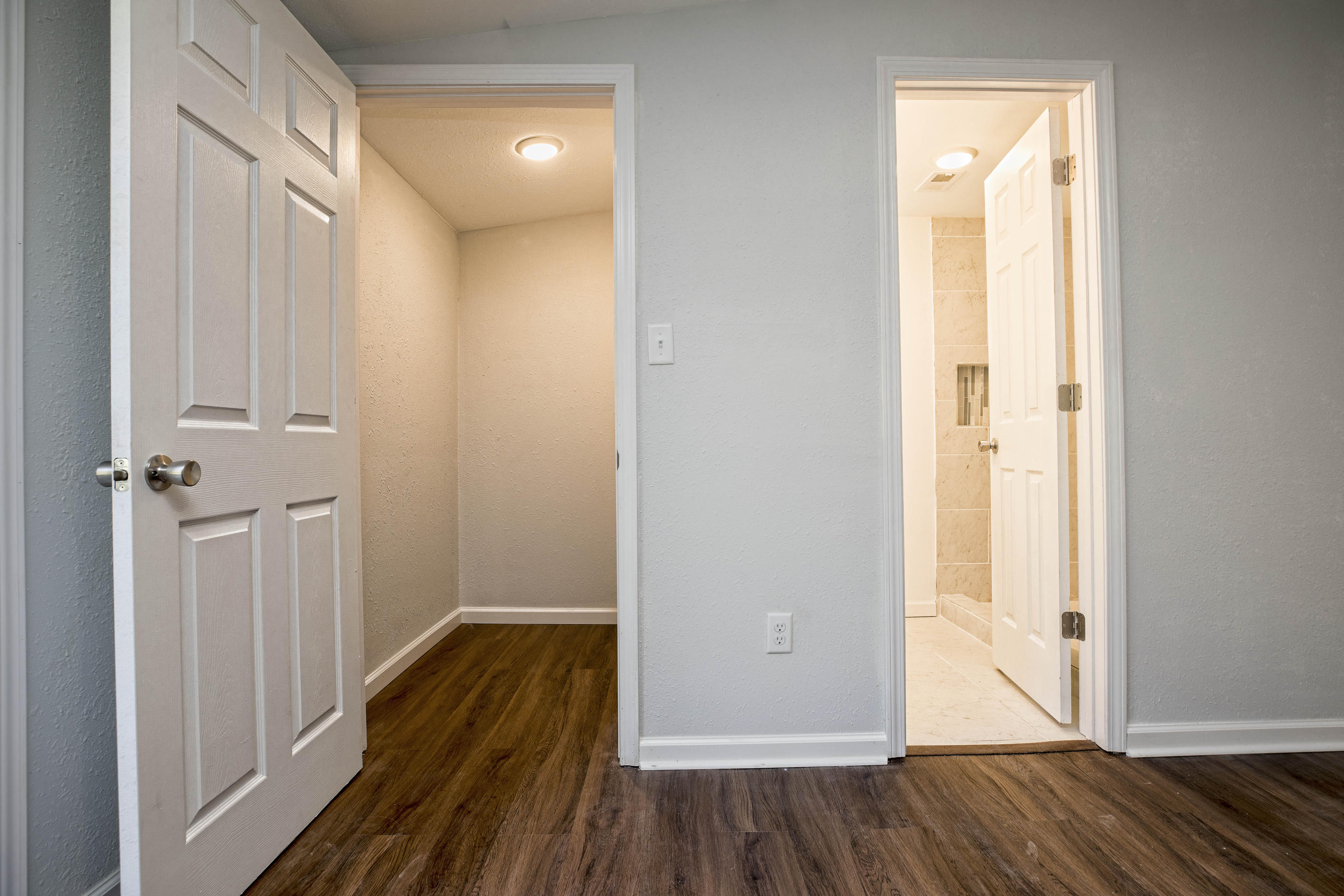 695 Ridge Lake Road Crestview, FL 32536 - Photo 21 of 27 a view of a hallway with wooden floor and closet