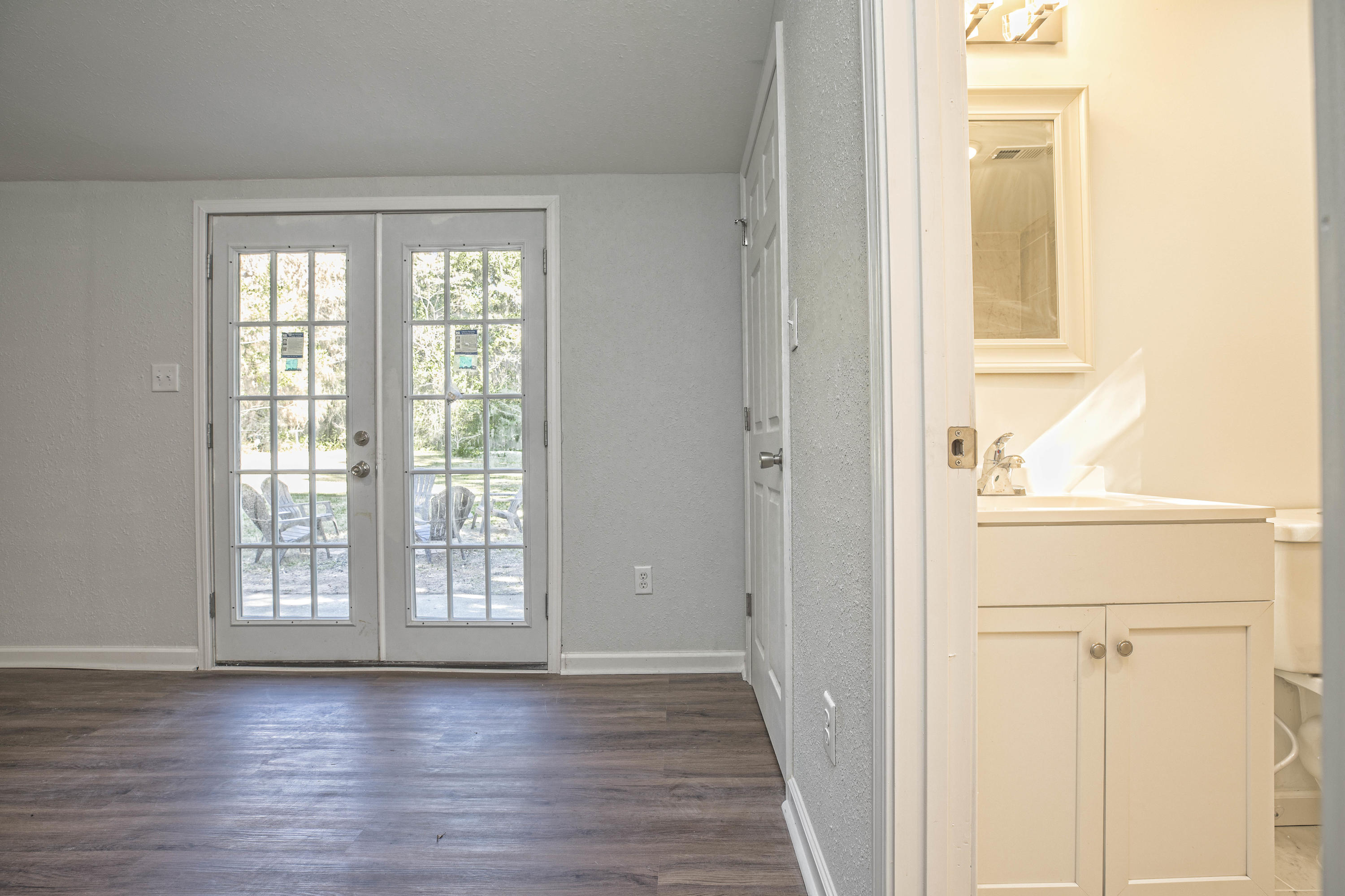 695 Ridge Lake Road Crestview, FL 32536 - Photo 24 of 27 a view of an empty room with wooden floor and a window