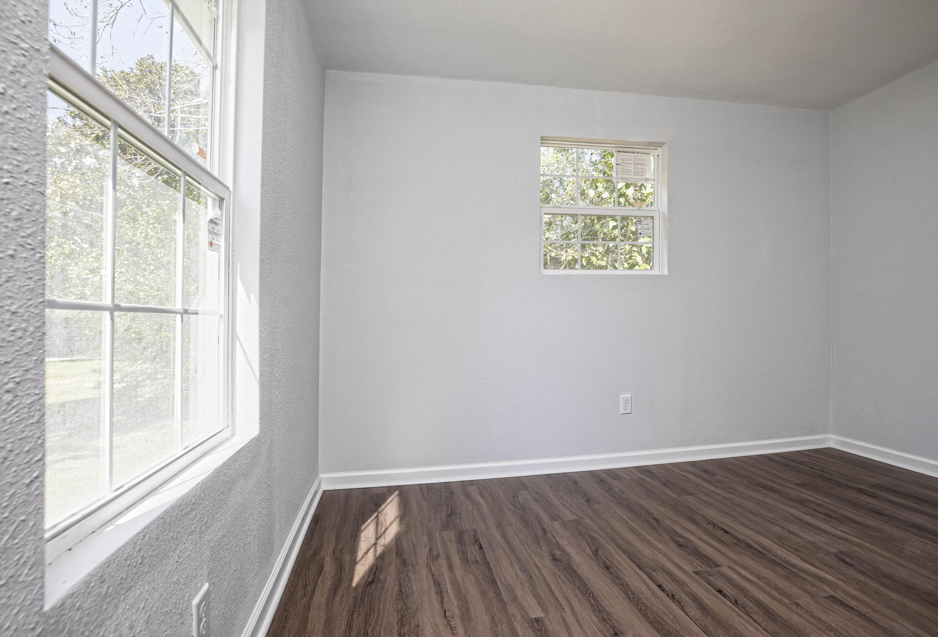 695 Ridge Lake Road Crestview, FL 32536 - Photo 26 of 27 a view of an empty room with wooden floor and a window