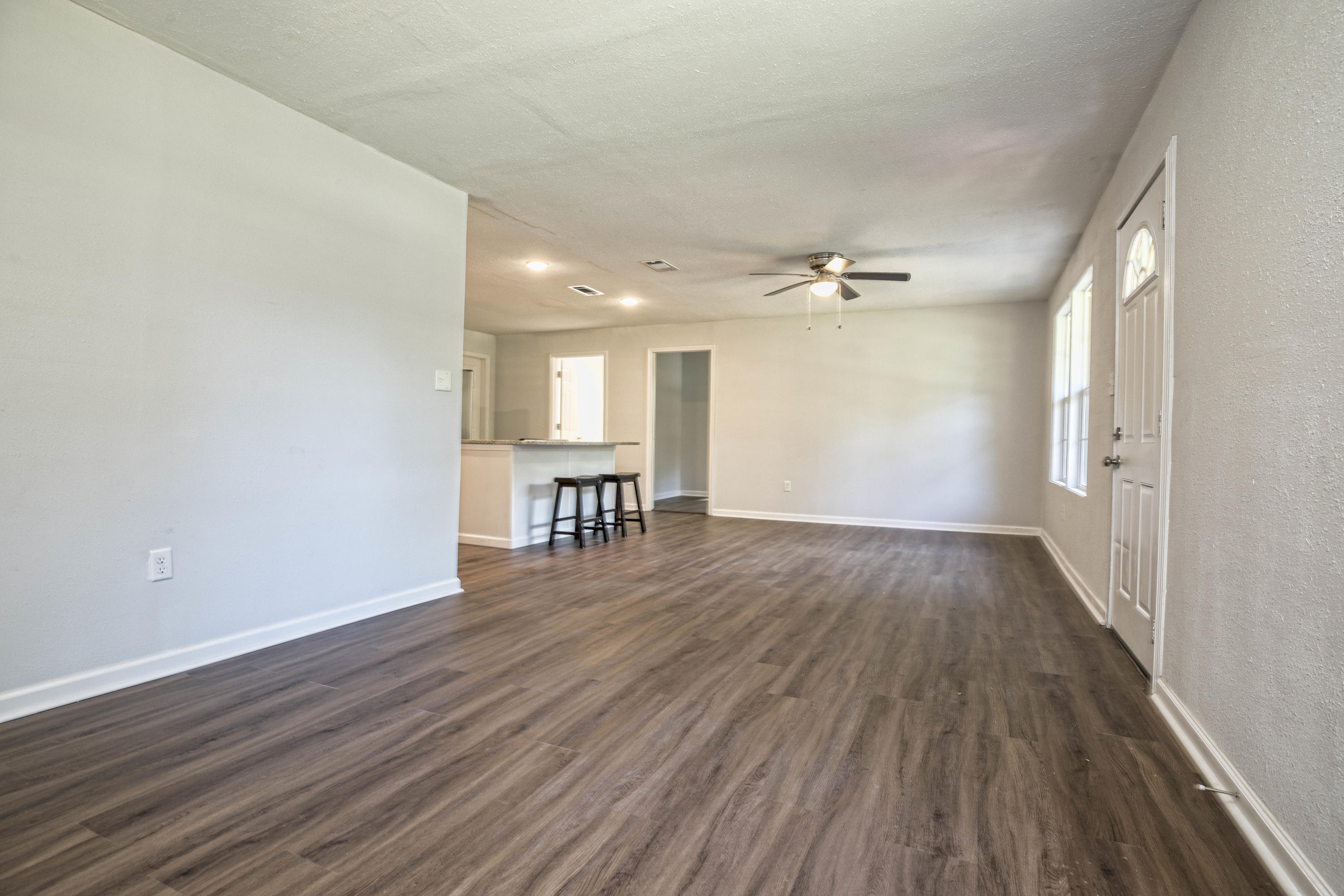 695 Ridge Lake Road Crestview, FL 32536 - Photo 4 of 27 wooden floor in an empty room with a window