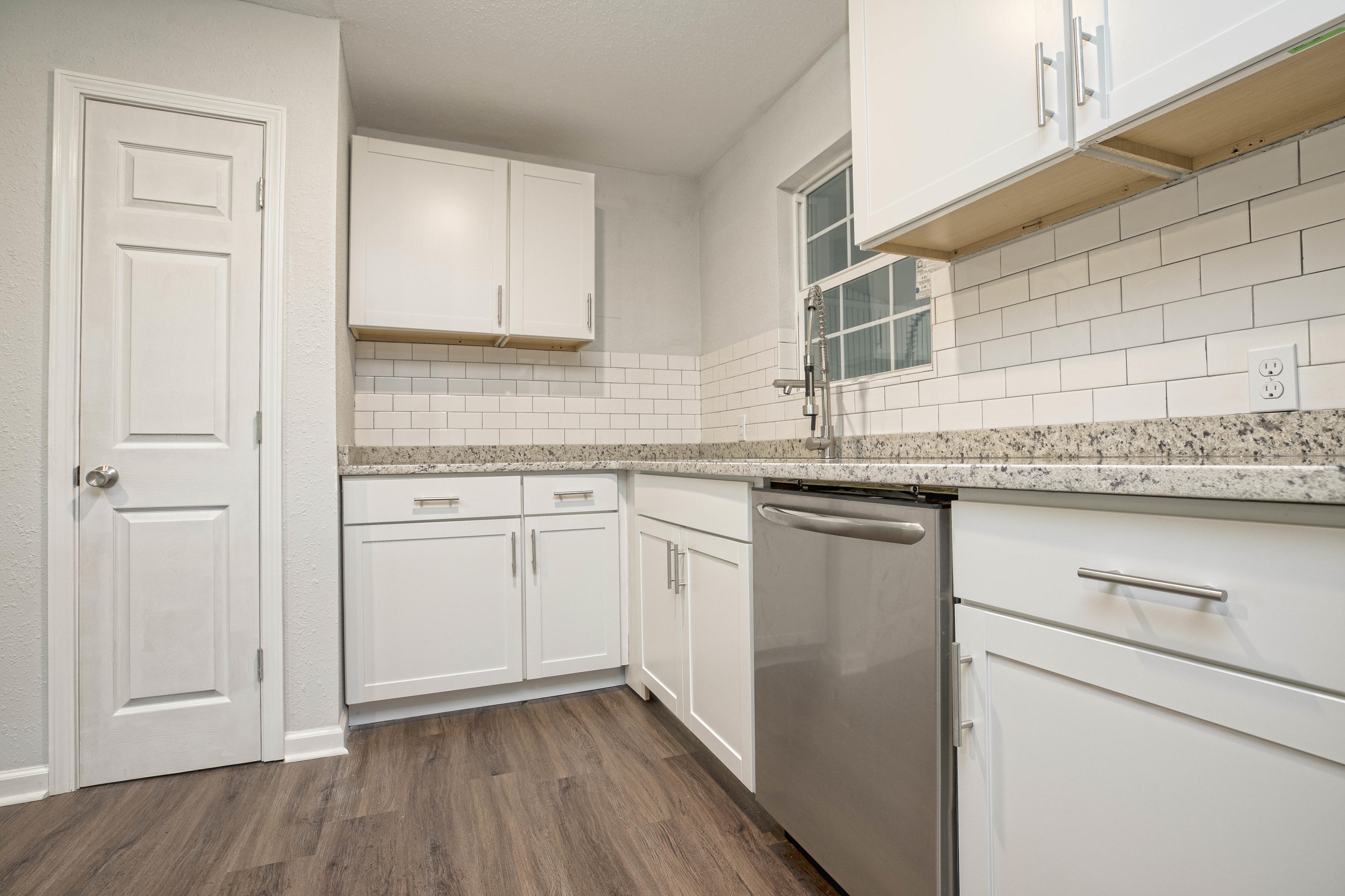 695 Ridge Lake Road Crestview, FL 32536 - Photo 5 of 27 a kitchen with stainless steel appliances granite countertop cabinets and wooden floor