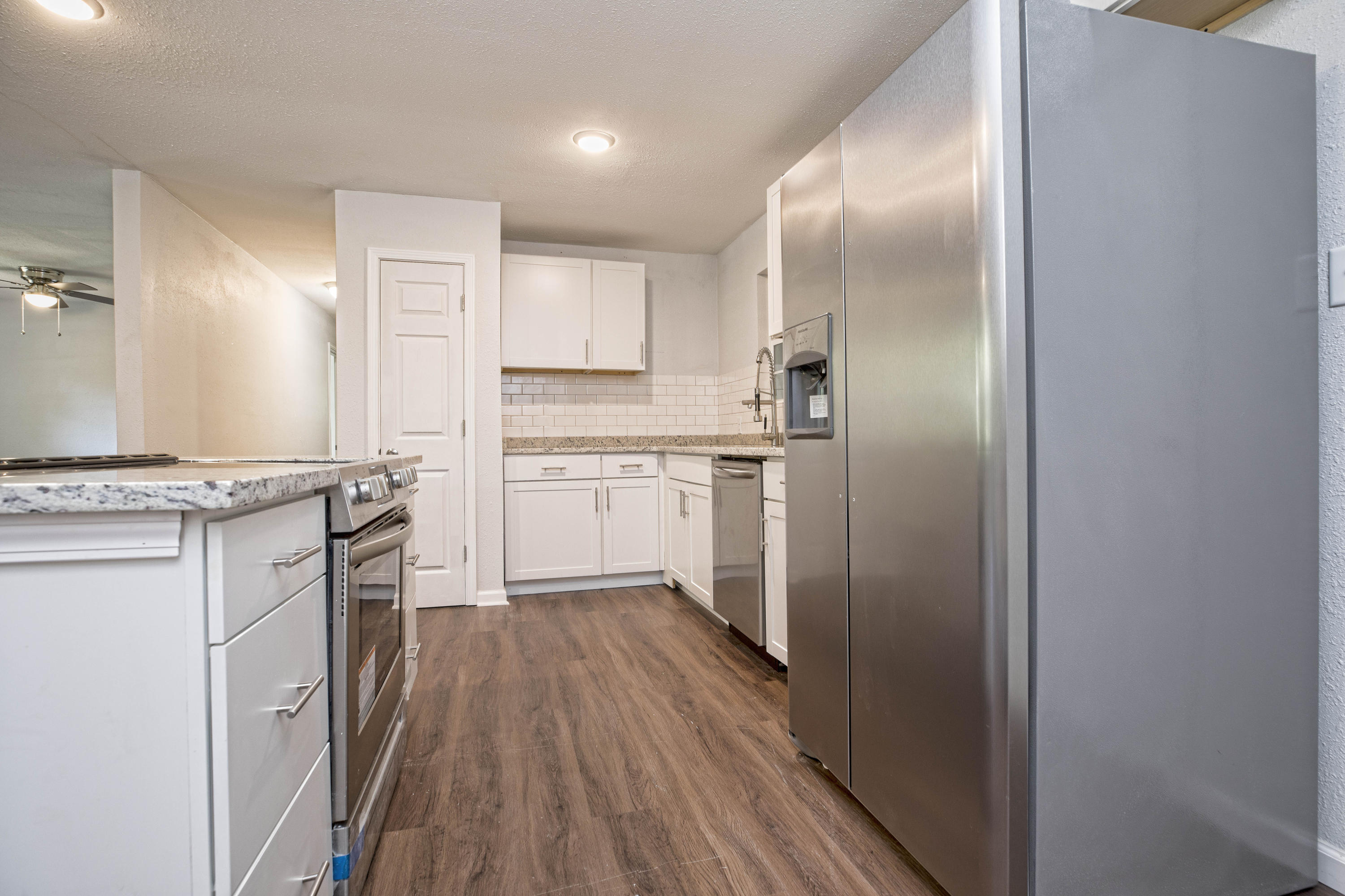 695 Ridge Lake Road Crestview, FL 32536 - Photo 9 of 27 a kitchen with white cabinets and stainless steel appliances