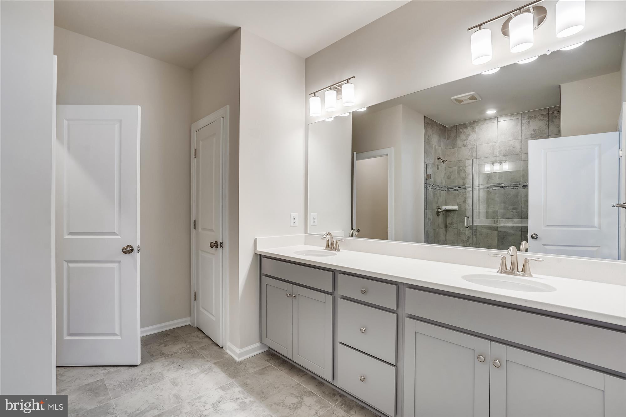 43341 Goshen Run Square Ashburn, VA 20148 - Photo 11 of 29 a bathroom with double sink and a mirror