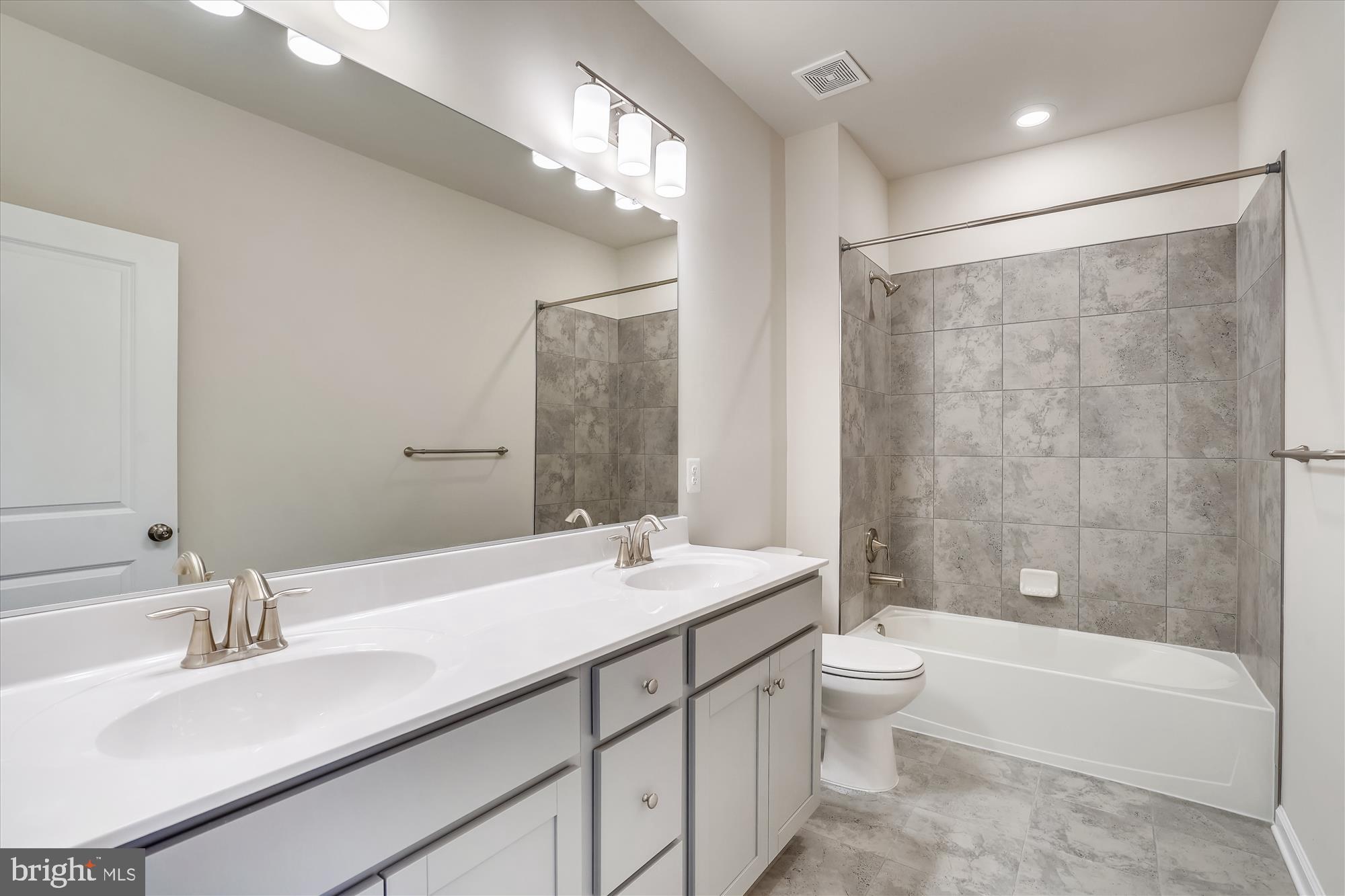 43341 Goshen Run Square Ashburn, VA 20148 - Photo 16 of 29 a bathroom with a double vanity sink toilet mirror and bathtub