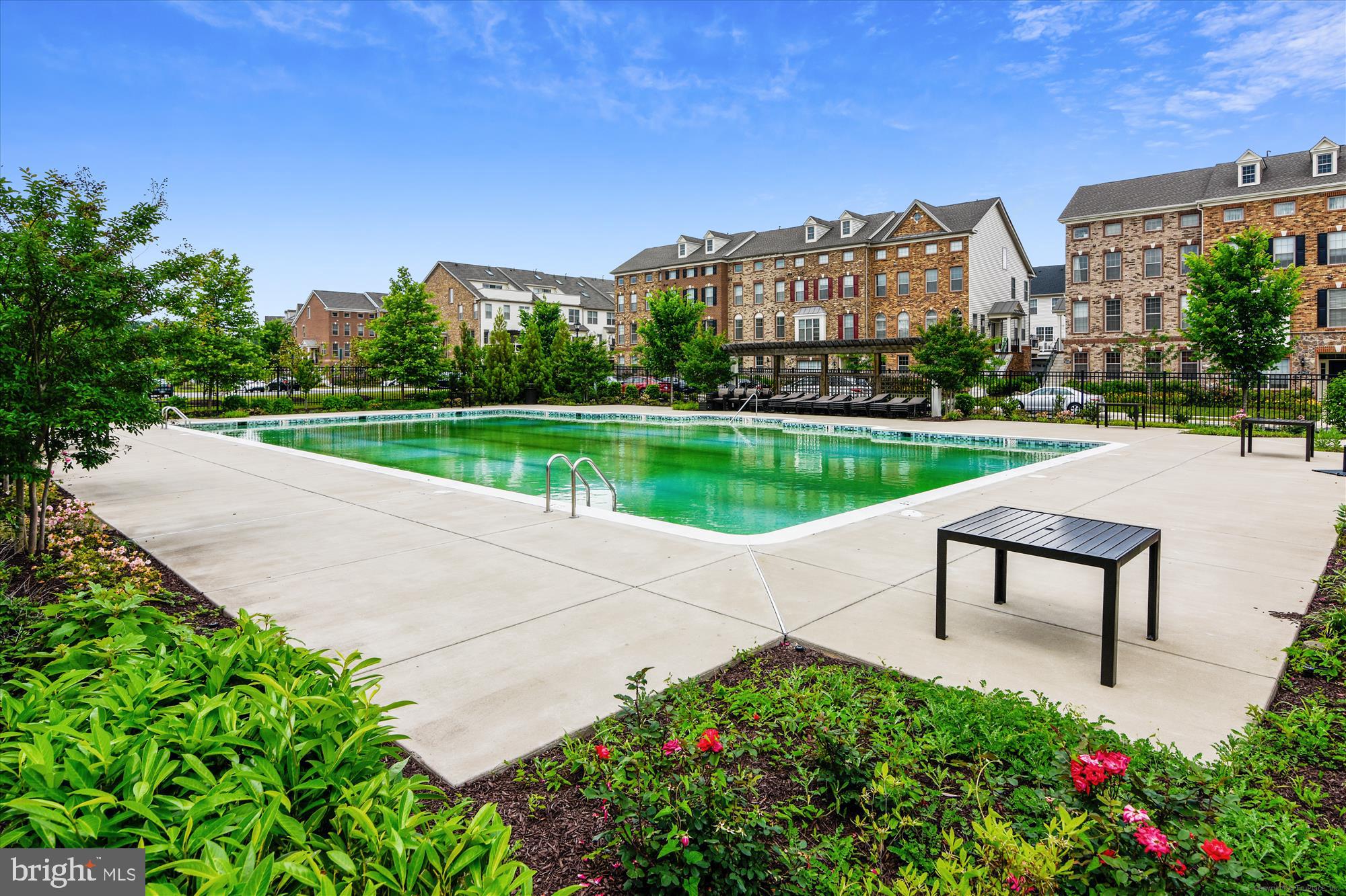 43341 Goshen Run Square Ashburn, VA 20148 - Photo 23 of 29 a view of a garden with a bench in front of the house