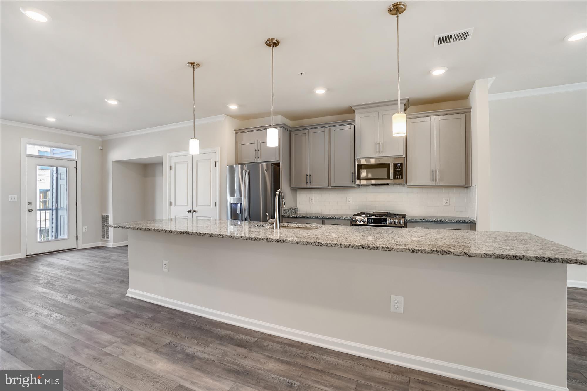 43341 Goshen Run Square Ashburn, VA 20148 - Photo 4 of 29 a large kitchen with stainless steel appliances granite countertop a sink a oven and a granite counter tops