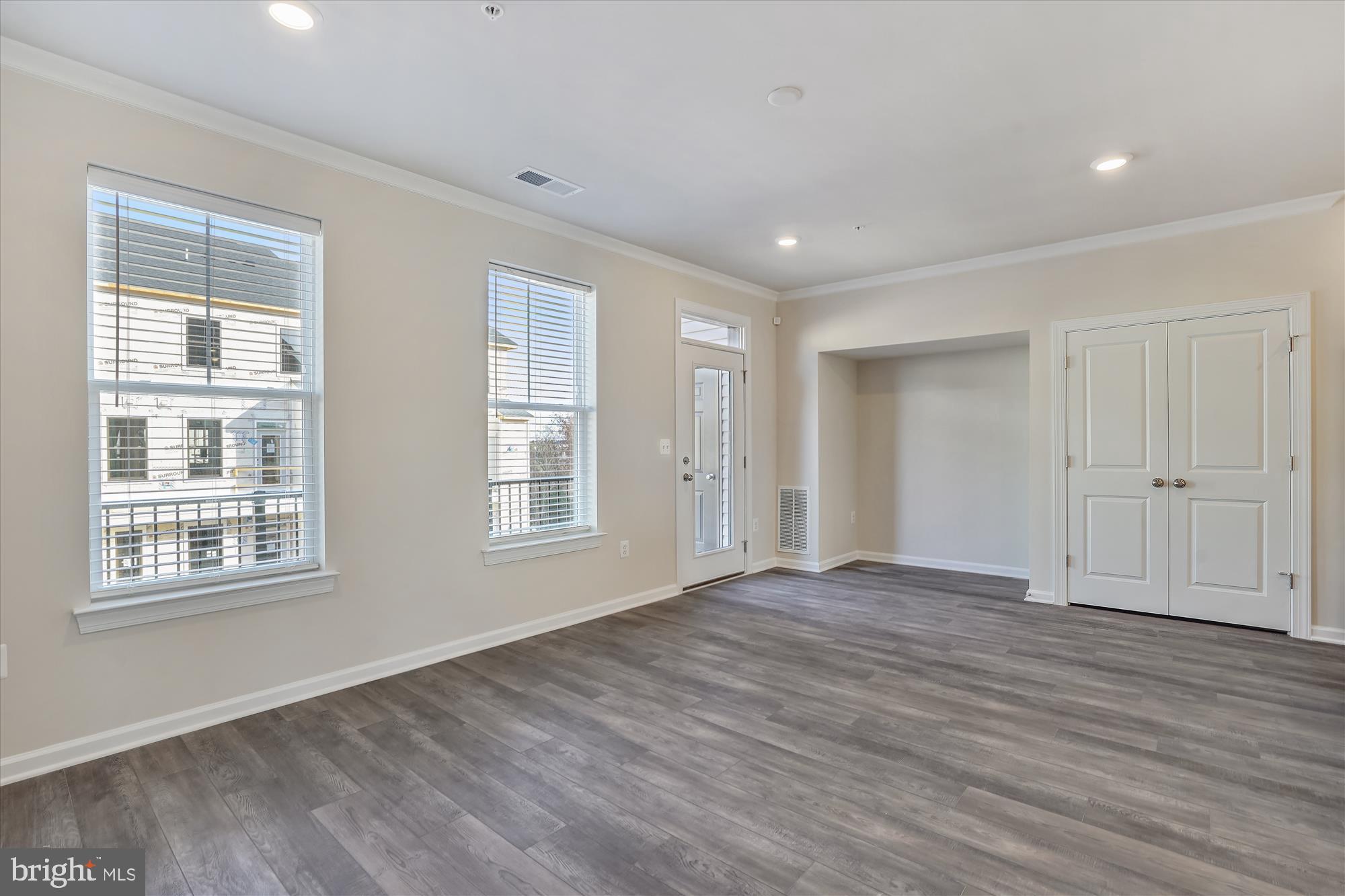 43341 Goshen Run Square Ashburn, VA 20148 - Photo 5 of 29 a view of an empty room with wooden floor and a window