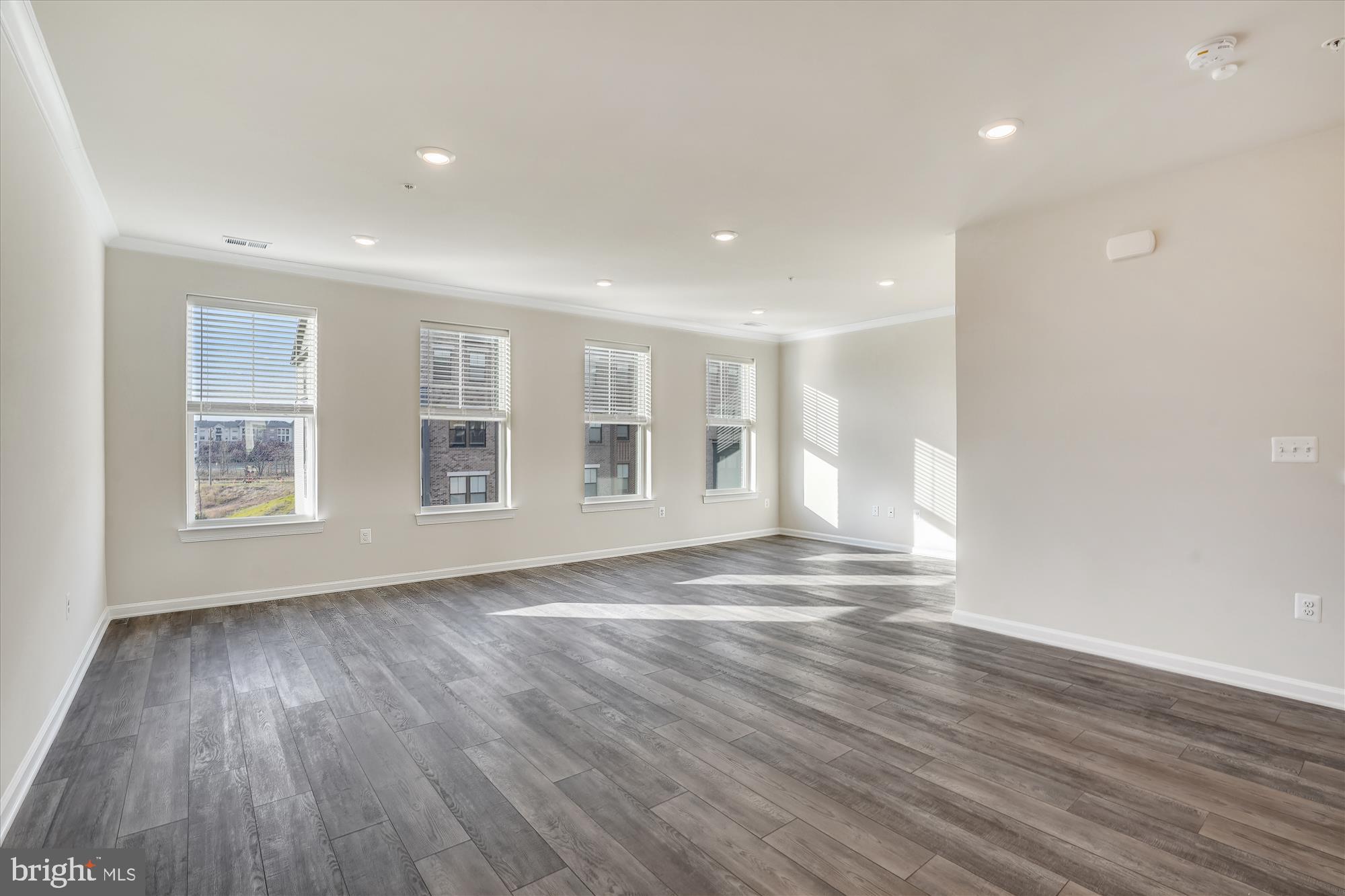 43341 Goshen Run Square Ashburn, VA 20148 - Photo 6 of 29 a view of empty room with wooden floor and fan