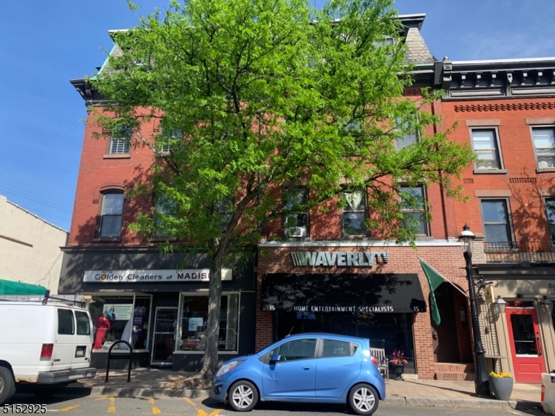 a front view of a building with parking