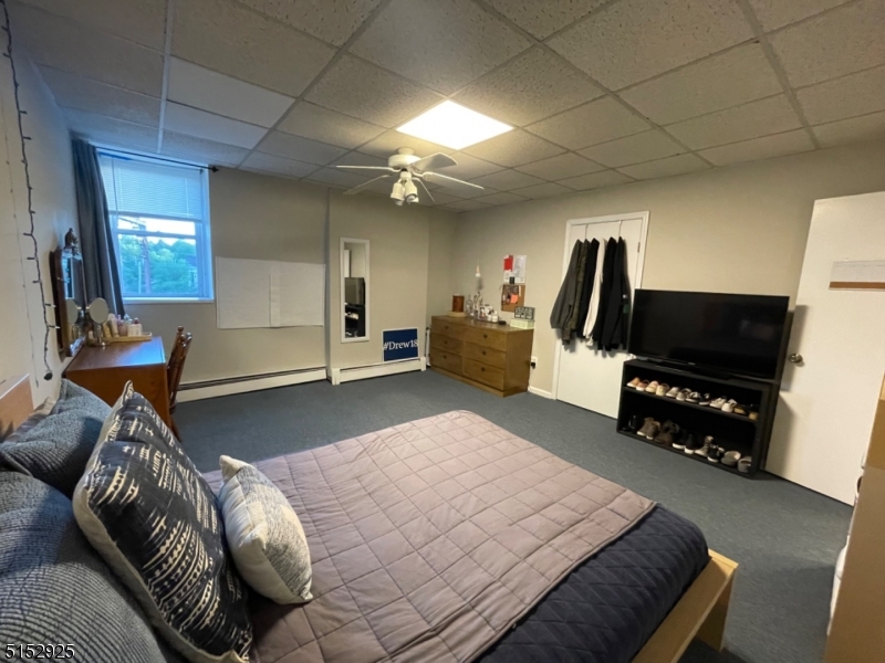 17 Waverly Place, Unit 9 Madison, NJ 07940 - Photo 11 of 15 a bedroom with furniture and a flat screen tv