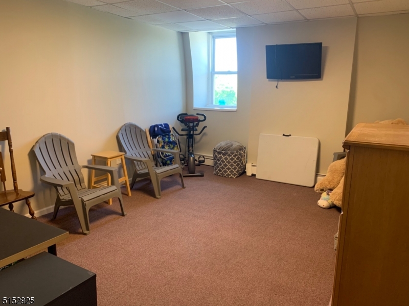 17 Waverly Place, Unit 9 Madison, NJ 07940 - Photo 14 of 15 a bedroom with a chair and a air conditioner vent