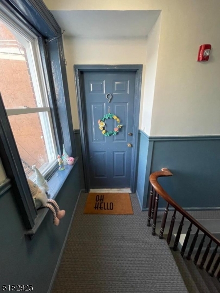 17 Waverly Place, Unit 9 Madison, NJ 07940 - Photo 2 of 15 a hallway with table and chairs