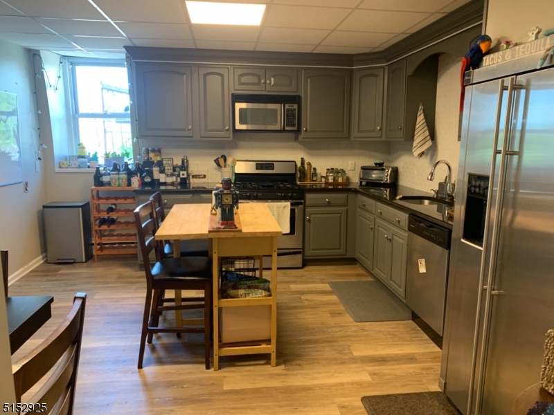 17 Waverly Place, Unit 9 Madison, NJ 07940 - Photo 3 of 15 a kitchen with stainless steel appliances granite countertop a stove a sink dishwasher a microwave oven and a refrigerator