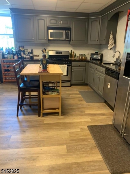 17 Waverly Place, Unit 9 Madison, NJ 07940 - Photo 4 of 15 a kitchen with stainless steel appliances granite countertop a stove a sink a microwave and a refrigerator