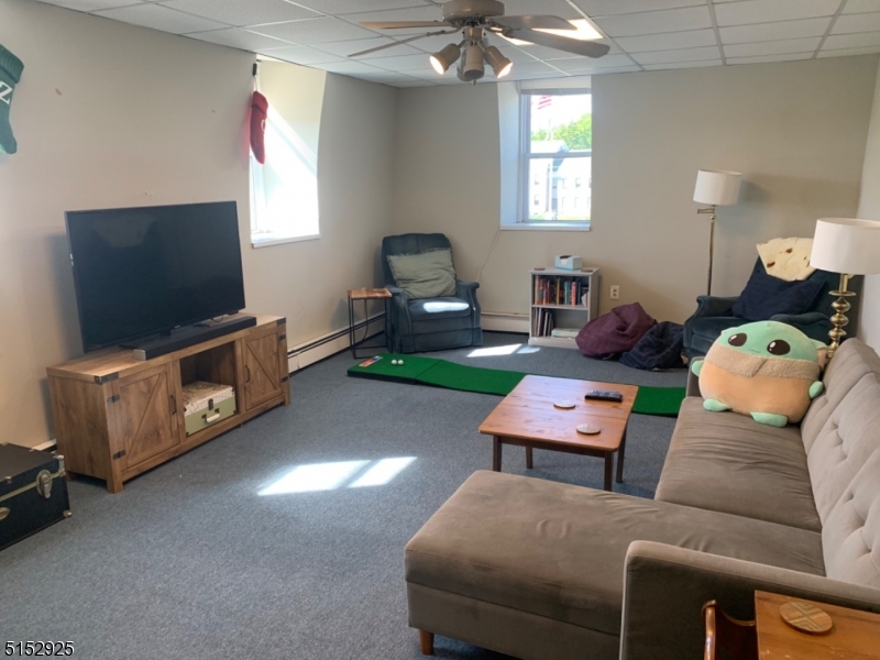 17 Waverly Place, Unit 9 Madison, NJ 07940 - Photo 6 of 15 a living room with furniture and a flat screen tv