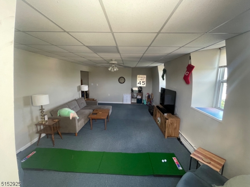 17 Waverly Place, Unit 9 Madison, NJ 07940 - Photo 7 of 15 a living room with furniture and a flat screen tv