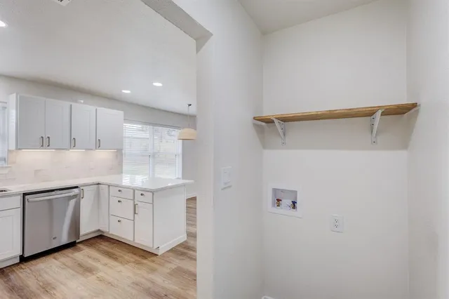 a kitchen with stainless steel appliances a sink and a refrigerator