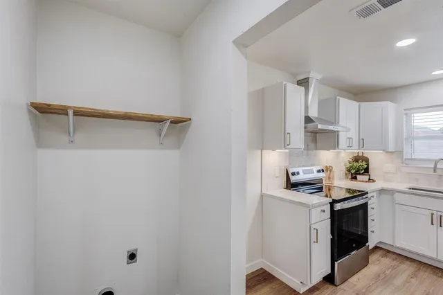 a kitchen with a sink cabinets and white appliances