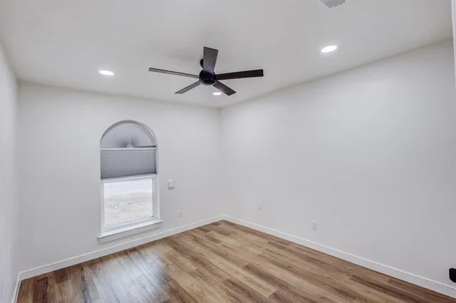 wooden floor in an empty room and a window