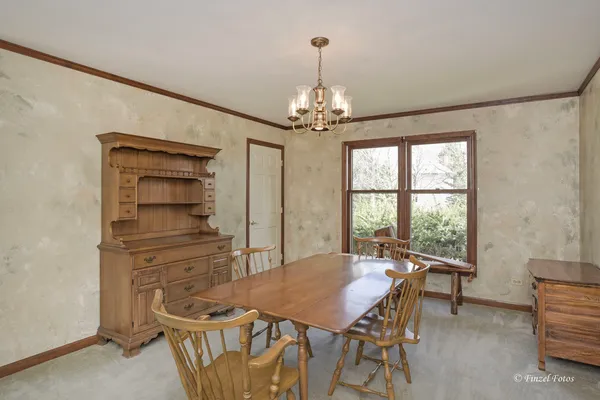 a view of a dining room with furniture and window
