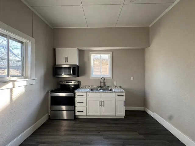 a view of a kitchen with wooden floor