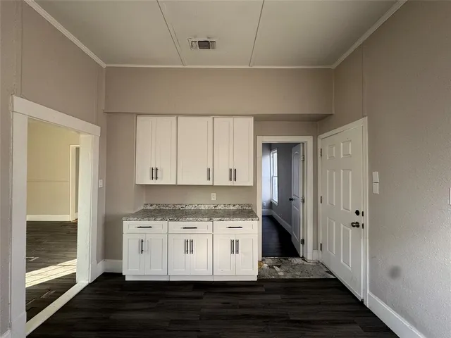 a view of a room with wooden floor and fan