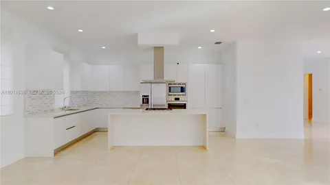 a kitchen with stainless steel appliances granite countertop a refrigerator and a stove