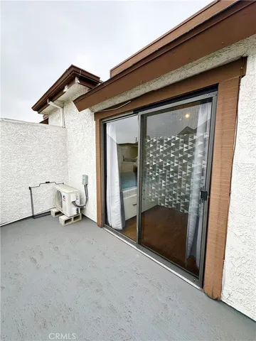 a view of an empty room with a fireplace and a window